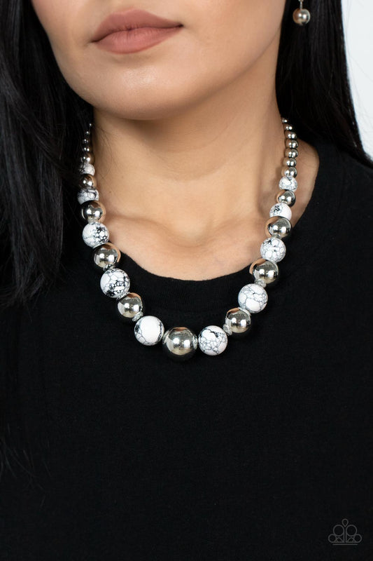 Stone Age Adventurer White Necklace - Paparazzi Accessories  Featuring a white and black marble finish, an earthy collection of faux stone and classic silver beads gradually increase in size as they alternate below the collar for a statement-making look. Features an adjustable clasp closure.  Sold as one individual necklace. Includes one pair of matching earrings.