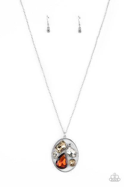 Scandalously Scattered Brown Necklace - Paparazzi Accessories  Varying in cut and shimmer, a mismatched collection of white, golden topaz, and classic topaz rhinestones haphazardly coalesce inside an oval silver frame, creating a mesmerizing pendant at the bottom of an extended silver chain. Features an adjustable clasp closure.  Sold as one individual necklace. Includes one pair of matching earrings.