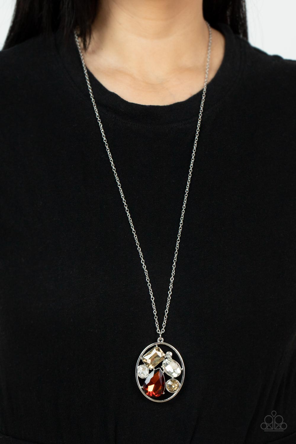 Scandalously Scattered Brown Necklace - Paparazzi Accessories  Varying in cut and shimmer, a mismatched collection of white, golden topaz, and classic topaz rhinestones haphazardly coalesce inside an oval silver frame, creating a mesmerizing pendant at the bottom of an extended silver chain. Features an adjustable clasp closure.  Sold as one individual necklace. Includes one pair of matching earrings.