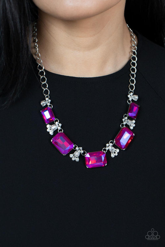 Flawlessly Famous Pink Necklace - Paparazzi Accessories  Featuring a stellar UV finish, an oversized collection of emerald cut pink rhinestones link with white rhinestone dotted teardrop rhinestone frames below the collar for a jaw-dropping display. Features an adjustable clasp closure.  Sold as one individual necklace. Includes one pair of matching earrings.