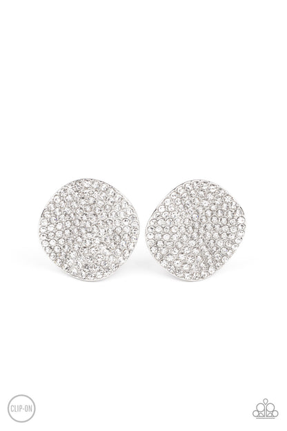 Lunch at the Louvre White Clip-On Earring - Paparazzi Accessories  The front of a warped silver disc is encrusted in row after row of blinding white rhinestones, resulting in a refined display. Earring attaches to a standard clip-on fitting.  Sold as one pair of clip-on earrings.