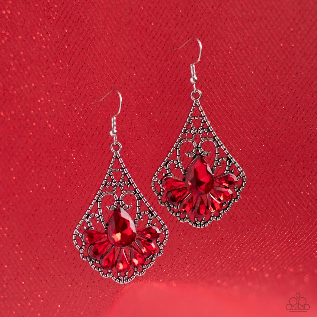 Exemplary Elegance Red Earring - Paparazzi Accessories  A sparkly collection of fiery red teardrop rhinestones fan out across the bottom of a textured filigree filled teardrop frame, creating an elegant centerpiece. Earring attaches to a standard fishhook fitting.  Featured inside The Preview at GLOW!  Sold as one pair of earrings.