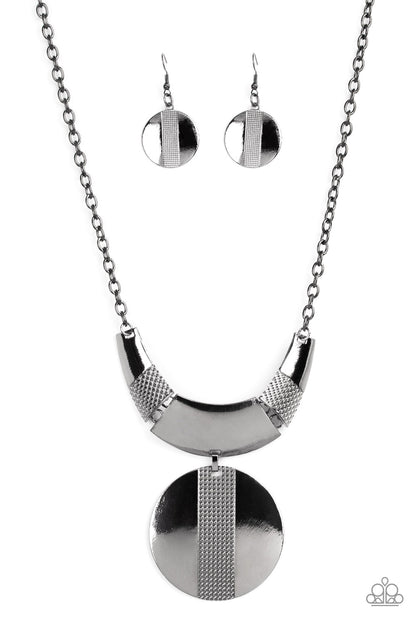 Metallic Enchantress Black Necklace - Paparazzi Accessories  Three curved gunmetal bars, stamped in studded texture accents, connect to a gunmetal chain across the collar. An oversized gunmetal disc, divided down the center with texture, swings from the bottom resulting in an edgy modern finish. Features an adjustable clasp closure.  Sold as one individual necklace. Includes one pair of matching earrings.