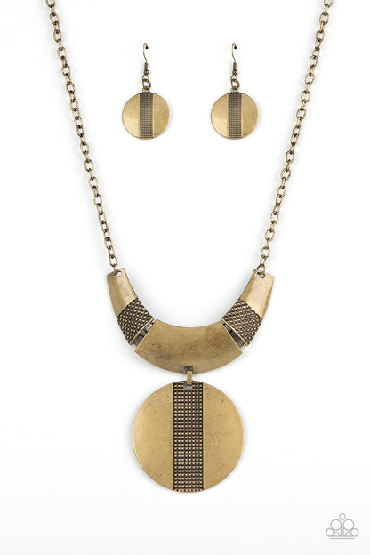Metallic Enchantress Brass Necklace - Paparazzi Accessories  Three wide, curved brass bars, stamped in studded textured accents, connect to a brass chain across the collar. A substantial brass disc, divided down the center with texture, swings from the bottom resulting in an edgy modern finish. Features an adjustable clasp closure.  Sold as one individual necklace. Includes one pair of matching earrings.