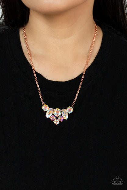 Lavishly Loaded Copper Necklace - Paparazzi Accessories  A glittering collection of marquise and round peach-colored gems encased in studded copper fittings, coalesce into a lavish frame that gives way to a classic shiny copper chain resulting in a glamorous finish below the collar. Features an adjustable clasp closure.  All Paparazzi Accessories are lead free and nickel free!  Sold as one individual necklace. Includes one pair of matching earrings.