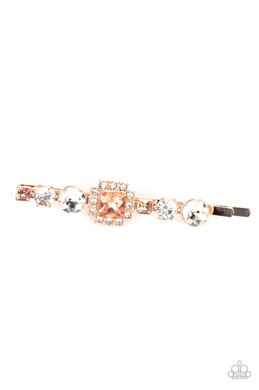 Couture Crasher Gold Hair Clip - Paparazzi Accessories  Featuring a brilliant radiant cut peach gem surrounded by a frame of dainty white rhinestones, a mismatched collection of white round and square peach rhinestones coalesce into a stunning display.  Sold as one individual hair clip.