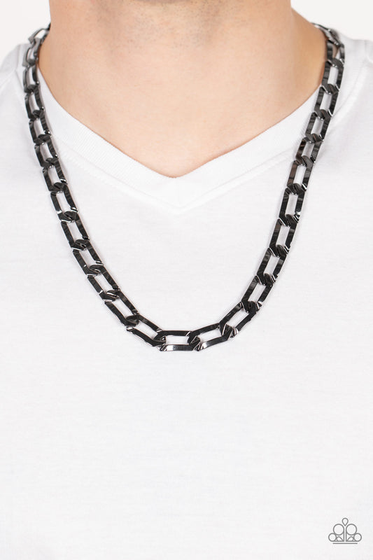 Full-Court Press Black Urban Necklace - Paparazzi Accessories  Crimped gunmetal oval links boldly interconnect across the chest, creating a classic urban look. Features an adjustable clasp closure.  All Paparazzi Accessories are lead free and nickel free!  Sold as one individual necklace.