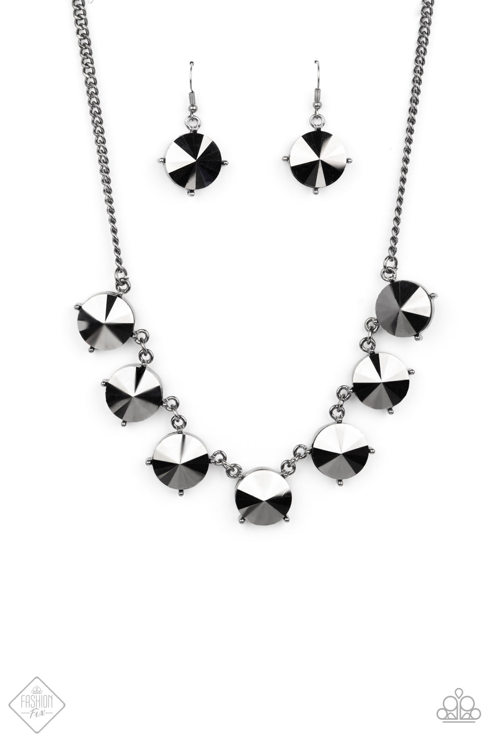 The SHOWCASE Must Go On Black Necklace - Paparazzi Accessories  Attached to glistening gunmetal chains, a dramatic collection of oversized hematite rhinestones boldly links into a smoldering statement piece below the collar. Features an adjustable clasp closure.  All Paparazzi Accessories are lead free and nickel free!  Sold as one individual necklace. Includes one pair of matching earrings.
