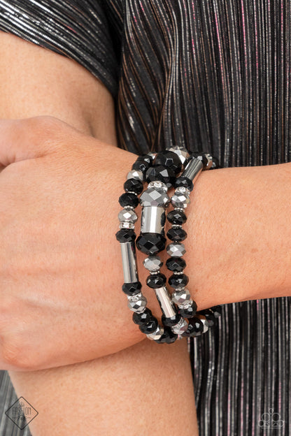 Dynamic Dazzle Black Coil Bracelet - Paparazzi Accessories  Stacks of black and silver faceted beads, interspersed with silver cylindrical accents and rhinestone-encrusted beads, are threaded along an infinity wrap-style bracelet making an intensely dynamic statement around the wrist.  Sold as one individual bracelet.