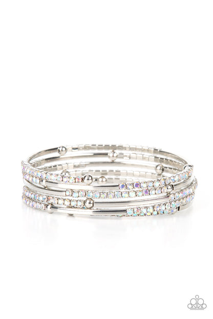 Camera Shy Simmer Multi Iridescent Bracelet - Paparazzi Accessories  A dainty infinity style bracelet is infused with glittery rows of iridescent rhinestones and curving silver frames, creating simmering layers around the wrist.  All Paparazzi Accessories are lead free and nickel free!  Sold as one individual bracelet.