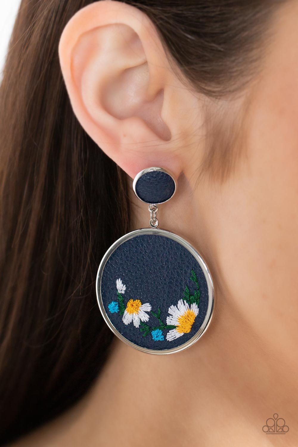 Embroidered Gardens Blue Post Earring - Paparazzi Accessories  A small Rhodonite leather disc, encased in a simple silver frame, anchors a larger Rhodonite circle that is adorned with fanciful embroidered flowers creating a whimsical lure. Earring attaches to a standard post fitting.  Sold as one pair of post earrings.