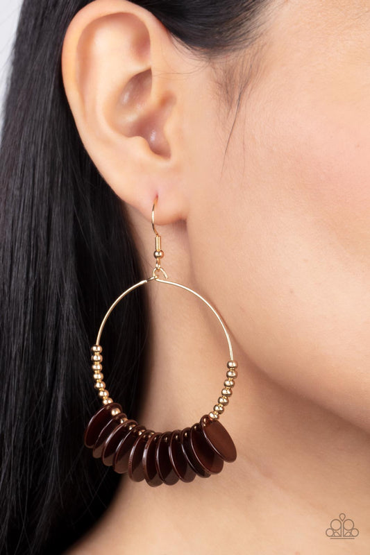 Caribbean Cocktail Brown Earring - Paparazzi Accessories  Shiny brown shell-like discs alternate with dainty gold beads around a petite circular gold wire frame for a touch of Caribbean charisma. Earring attaches to a standard fishhook fitting.  Sold as one pair of earrings.