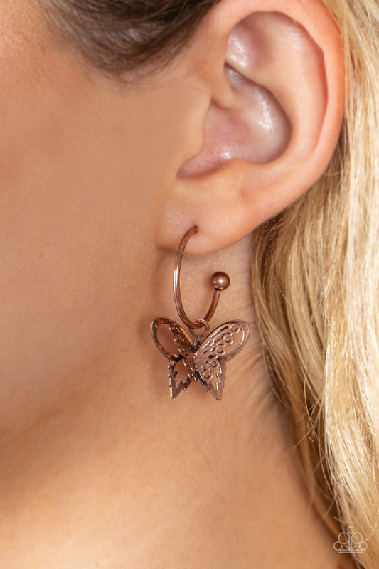 Butterfly Freestyle Copper Earring - Paparazzi Accessories  An airy copper butterfly charm glides along a dainty copper hoop, creating a fluttering fashion. Earring attaches to a post fitting. Hoop measures approximately 3/4" in diameter.  Sold as one pair of hoop earrings.
