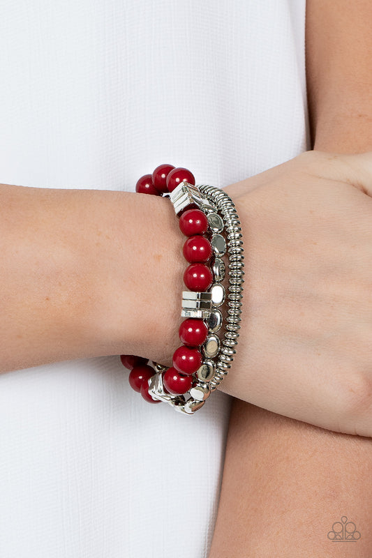 Tour de Tourist Red Bracelet - Paparazzi Accessories  A mismatched collection of silver discs, silver cubes, bubbly red acrylic, and silver pebble-like beads are threaded along stretchy bands around the wrist, creating fiery layers.  Sold as one set of three bracelets.