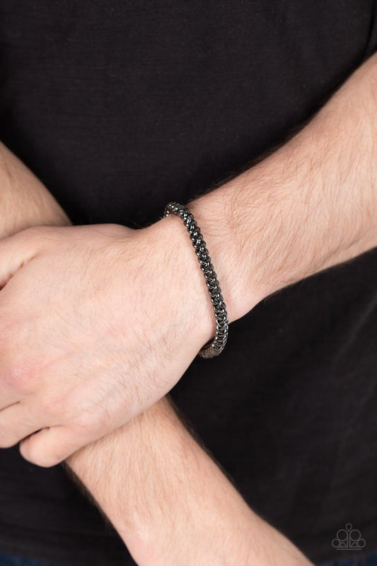 Setting The Pace Black Urban Bracelet - Paparazzi Accessories  Featuring round links, a gunmetal chain is threaded along a stretchy band around the wrist for a classic urban look.  Sold as one individual bracelet.