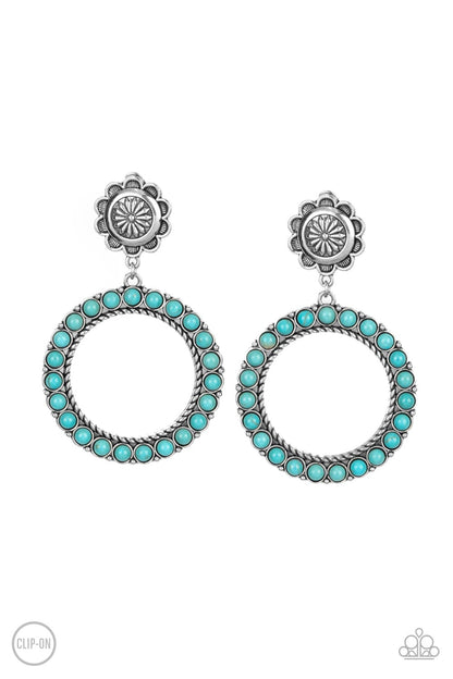 Playfully Prairie Blue Clip-On Earring - Paparazzi Accessories  Featuring studded and twisted rope-like silver accents, a turquoise stone dotted hoop swings from the bottom of a rustic silver flower for a whimsically floral fashion. Earring attaches to a standard clip-on fitting.  Sold as one pair of clip-on earrings.