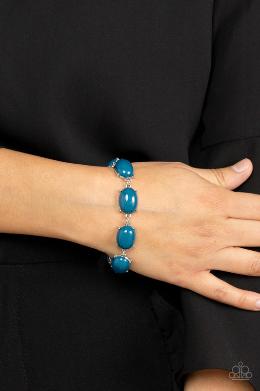 Confidently Colorful - Blue Item #P9WH-BLXX-258XX Featuring pronged silver fittings, an oversized collection of oval Mykonos Blue beads delicately link around the wrist for a dramatic pop of color. Features an adjustable clasp closure.  Sold as one individual bracelet.