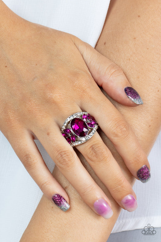 Cosmic Clique Pink Ring - Paparazzi Accessories  Bordered in dainty rows of glassy white rhinestones, leafy pink rhinestones bloom from a dramatically oversized pink oval rhinestone that coalesces into a glamorous centerpiece atop the finger. Features a stretchy band for a flexible fit.  Sold as one individual ring.  P4RE-PKXX-250XX
