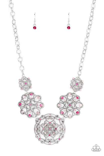 Royally Romantic Pink Necklace - Paparazzi Accessories  Spiraling with heart shaped filigree patterns, a mismatched collection of silver mandala-like frames delicately link below the collar. A smattering of dark and light pink rhinestones adorn the ornate frames, adding a spritz of glitter to the regal display. Features an adjustable clasp closure.  Sold as one individual necklace. Includes one pair of matching earrings.