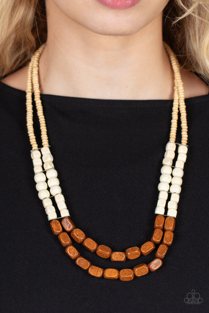Bermuda Bellhop Brown Necklace - Paparazzi Accessories  Varying in shape, size, and color, an earthy collection of tan, white, and brown wood beads are threaded along invisible wire across the chest, creating tropical inspired layers. Features an adjustable clasp closure.  Sold as one individual necklace. Includes one pair of matching earrings.