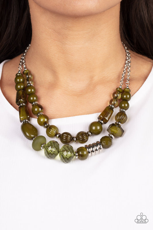 Pina Colada Paradise Green Necklace - Paparazzi Accessories  Varying in shape, size, and opacity, a refreshing collection of Olive Branch acrylic and crystal-like beads join silver discs along invisible wires that flawlessly layer below the collar for an earthy pop of color. Features an adjustable clasp closure.  Sold as one individual necklace. Includes one pair of matching earrings.