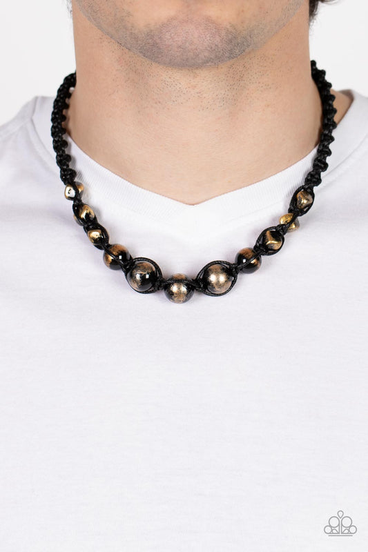 Loose Cannon Gold Urban Necklace - Paparazzi Accessories  Brushed in shiny black accents, a gritty collection of faceted and round gold beads are knotted in place with braided black cording below the collar for an urban flair. Features a button loop closure.  Sold as one individual necklace.