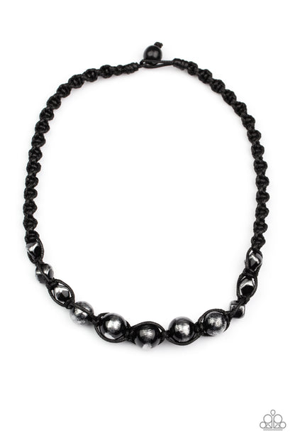 Loose Cannon Black Urban Necklace - Paparazzi Accessories  Brushed in shiny black accents, a gritty collection of faceted and round silver beads are knotted in place with braided black cording below the collar for an urban flair. Features a button loop closure.  Sold as one individual necklace.