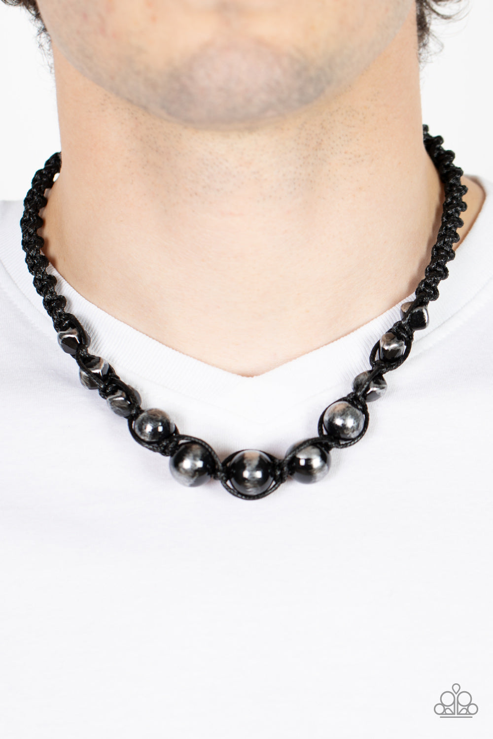 Loose Cannon Black Urban Necklace - Paparazzi Accessories  Brushed in shiny black accents, a gritty collection of faceted and round silver beads are knotted in place with braided black cording below the collar for an urban flair. Features a button loop closure.  Sold as one individual necklace.