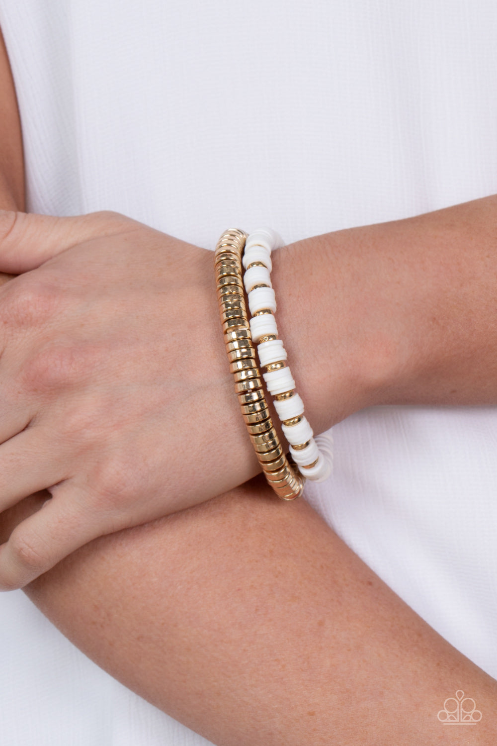 Catalina Marina White Bracelet - Paparazzi Accessories  Infused with stretchy bands, a row of gold disc beads joins a strand of rubbery white and gold discs around the wrist, resulting in a modern duo.  Sold as one pair of bracelets.