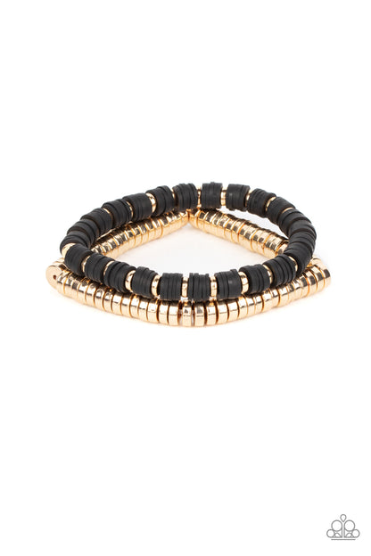 Catalina Marina Black Bracelet - Paparazzi Accessories  Infused with stretchy bands, a row of gold disc beads joins a strand of rubbery black and gold discs around the wrist, resulting in a modern duo.  Sold as one pair of bracelets.