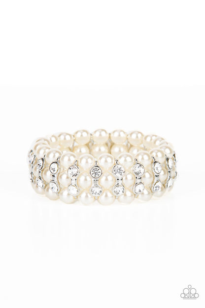 Eiffel Tower Elegance White Pearl Bracelet - Paparazzi Accessories  Stacked rows of bubbly white pearls alternate with white rhinestone encrusted silver frames along stretchy bands, adding a timeless twist to the traditional pearl palette.  Sold as one individual bracelet.