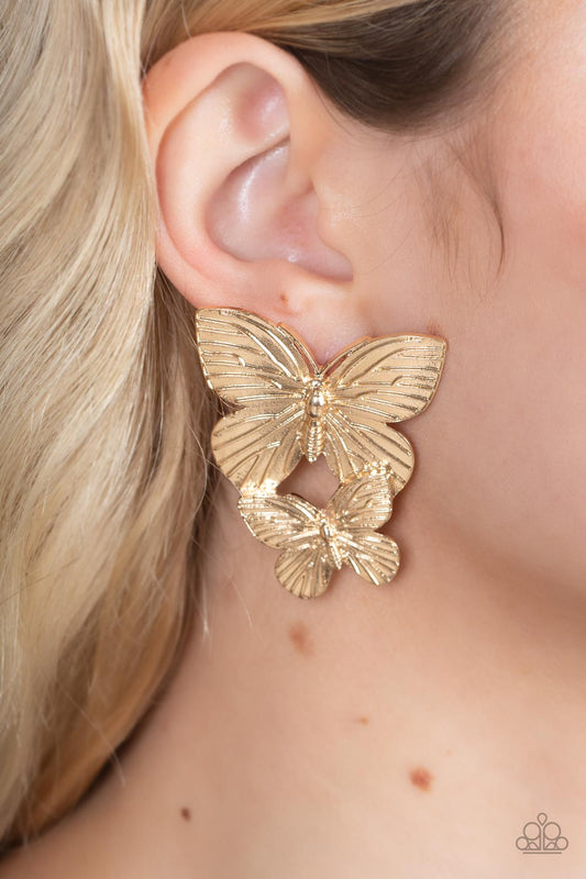 Blushing Butterflies Gold Earring - Paparazzi Accessories  Veined with lifelike textures, a pair of golden butterflies flutters from the ear for a whimsical fashion. Earring attaches to a standard post fitting.  Sold as one pair of post earrings.