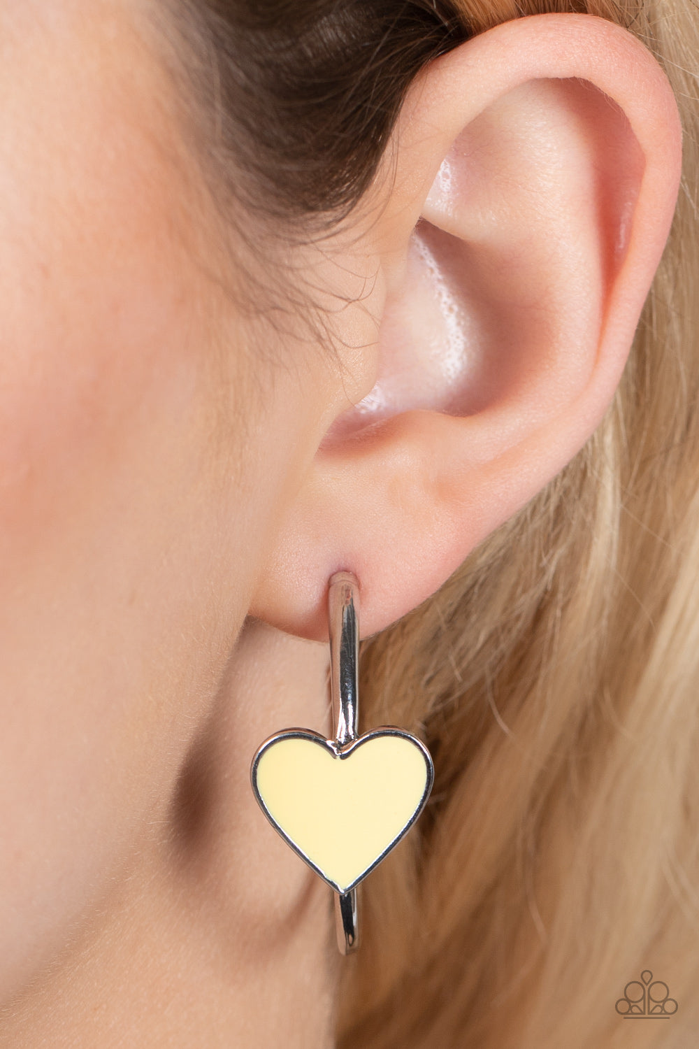 Kiss Up Yellow Hoop Earring - Paparazzi Accessories  A charming Illuminating heart adorns the front of a classic silver hoop resulting in a whimsical fashion. Earring attaches to a standard post fitting. Hoop measures approximately 1 1/4" in diameter.  All Paparazzi Accessories are lead free and nickel free!  Sold as one pair of hoop earrings.