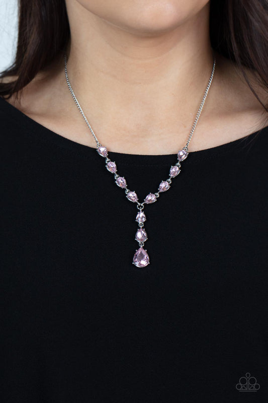 Park Avenue A-Lister Pink Rhinestone Necklace - Paparazzi Accessories  Cascading series of sparkly pink teardrop rhinestones delicately link into a chain of graduating teardrops, resulting in an elegant extended pendant below the collar. Features an adjustable clasp closure.  Sold as one individual necklace. Includes one pair of matching earrings.  P2DA-PKXX-158XX
