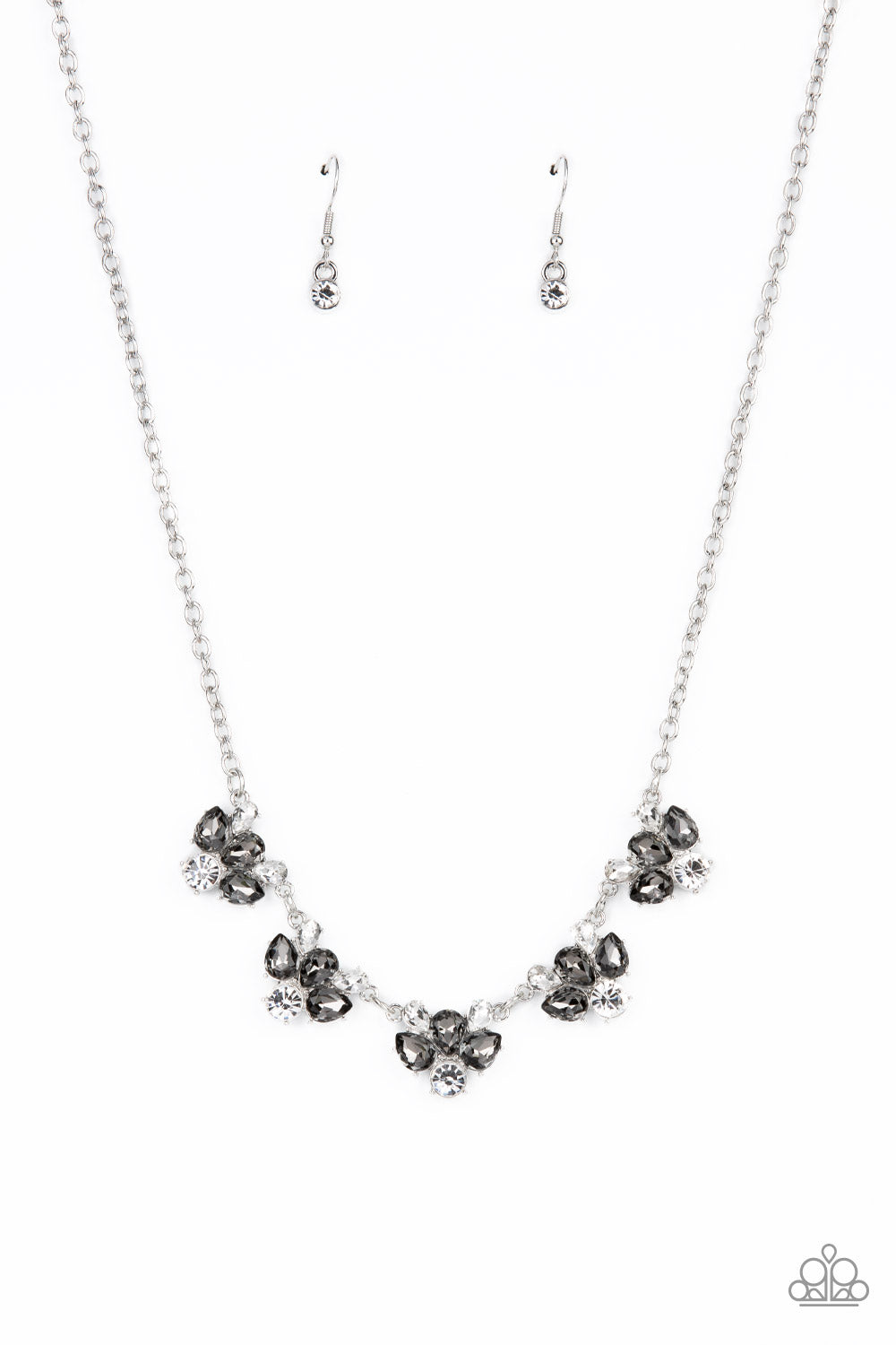 Envious Elegance Silver Necklace - Paparazzi Accessories  Featuring round and teardrop cuts, white and smoky rhinestones delicately link into a sparkling statement piece that results into an envious glow below the collar. Features an adjustable clasp closure.  Sold as one individual necklace. Includes one pair of matching earrings.