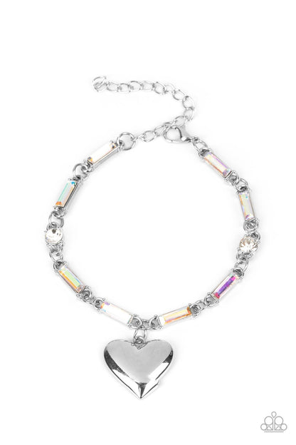 Sweetheart Secrets Multi Bracelet - Paparazzi Accessories  Encased in sleek silver fittings, classic white rhinestones and emerald cut iridescent rhinestones delicately link into a sparkly chain around the wrist. A shiny silver heart charm swings from the glittery compilation, adding a flirtatious shimmer. Features an adjustable clasp closure.  Sold as one individual bracelet.