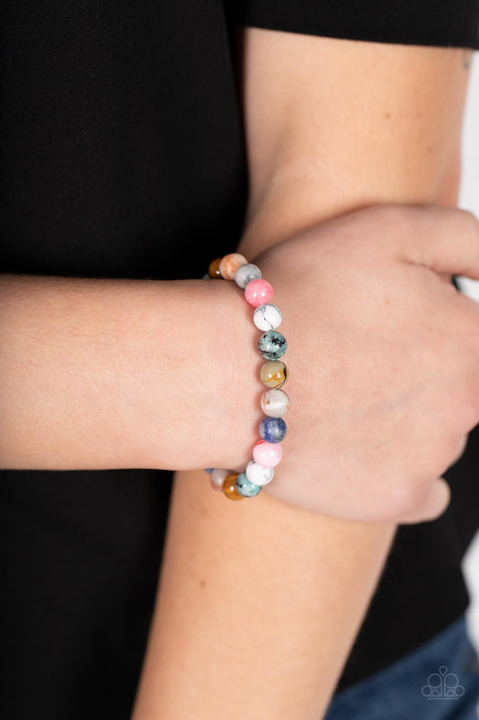 Stone Chakra Multi Urban Bracelet - Paparazzi Accessories  Infused with silver accents, a colorful collection of natural stones are threaded along a stretchy band around the wrist for a tranquil look.  Sold as one individual bracelet.