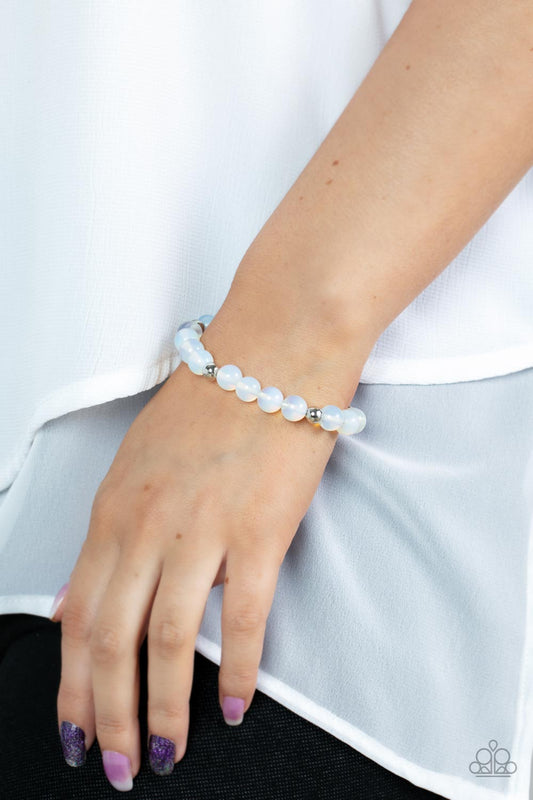 Forever and a DAYDREAM White Urban Bracelet - Paparazzi Accessories  Infused with silver accents, a dreamy collection of glassy and opalescent white beads are threaded along a stretchy band around the wrist for an enchanting glow.  Sold as one individual bracelet.