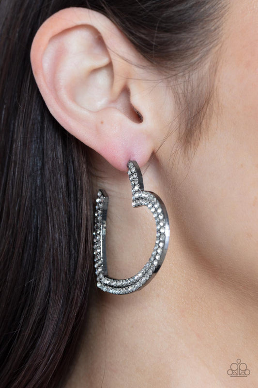 AMORE to Love Black Heart Hoop Earring - Paparazzi Accessories  Tow rows of blinding white rhinestones are encrusted along the front of a heart shaped gunmetal hoop, creating a heart-stopping sparkle. Hoop measures approximately 2" in diameter. Earring attaches to a standard post fitting.  Sold as one pair of hoop earrings.