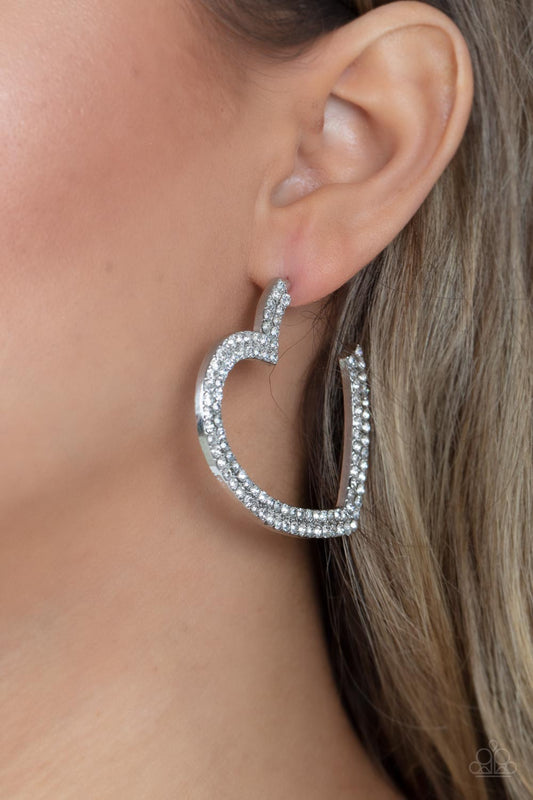 AMORE to Love White Hoop Earring - Paparazzi Accessories  Two rows of blinding white rhinestones are encrusted along the front of a heart shaped silver hoop, creating a heart-stopping sparkle. Hoop measures approximately 2" in diameter. Earring attaches to a standard post fitting.  Sold as one pair of hoop earrings.