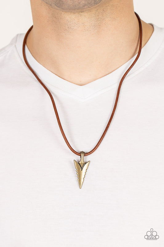 Pharaohs Arrow Brass Urban Necklace - Paparazzi Accessories  A brass arrowhead inspired pendant glides along a leathery brown cord below the collar, creating authentic edge. Features an adjustable clasp closure.  Sold as one individual necklace.