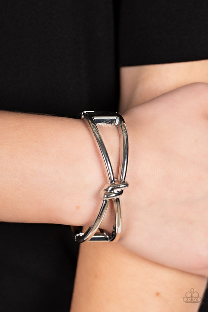 KNOT My First Rodeo Silver Bracelet - Paparazzi Accessories  Striking silver bars delicately knot at the top and bottom of the wrist, resulting in an edgy bangle-like bracelet. Features a hinged closure.  Sold as one individual bracelet.