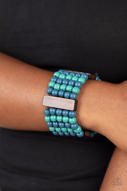 Island Soul Blue Wood Bracelet - Paparazzi Accessories  Colorful layers of blue and turquoise wooden beads are threaded along stretchy bands between dark brown wooden bars creating stacks of subtle bliss around the wrist.  Sold as one individual bracelet.