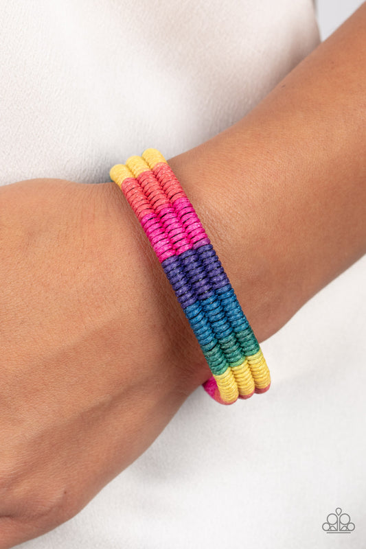 Rainbow Renegade Multi Bracelet - Paparazzi Accessories  Colorful sections of pink, red, yellow, green, blue, and purple cords ornately wrap and weave around three black bands, coalescing into a radiant rainbow around the wrist. Features an adjustable sliding knot closure.  Sold as one individual bracelet.