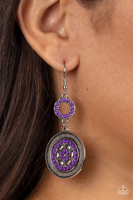 Meadow Mantra - Purple Item #P5WH-PRXX-242XX Dotted in dainty purple seed beads, a dainty silver hoop links to an ornate silver disc for a colorful floral finish. Earring attaches to a standard fishhook fitting.  Sold as one pair of earrings.