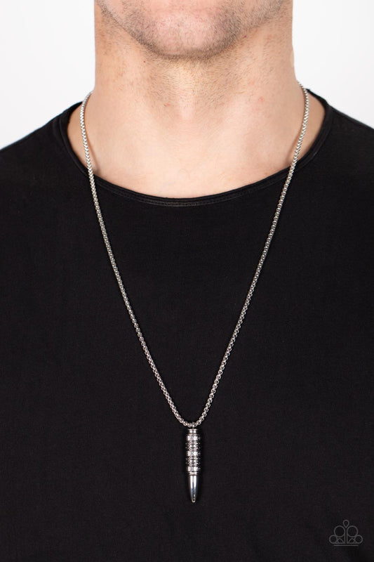 Highland Hunter Silver Necklace - Paparazzi Accessories  A tribal-inspired motif wraps around a silver bullet-shaped pendant at the end of a round silver box chain resulting in a striking ancestral adornment below the collar. Features an adjustable clasp closure.  All Paparazzi Accessories are lead free and nickel free!  Sold as one individual necklace.