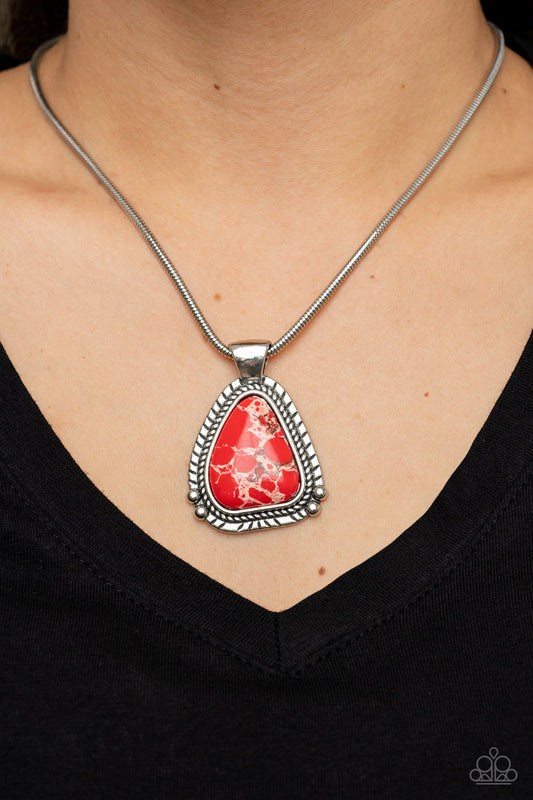 Artisan Adventure Red Necklace - Paparazzi Accessories  Featuring a studded and textured silver frame, an asymmetrical red stone pendant glides along a rounded silver snake chain below the collar for an authentically artisan-inspired fashion. Features an adjustable clasp closure.  Sold as one individual necklace. Includes one pair of matching earrings.
