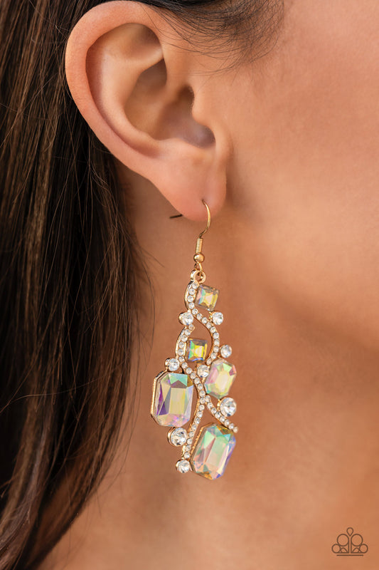 Interstellar Illumination Multi Earring - Paparazzi Accessories  Golden ribbons of glassy white rhinestones whirl around a chandelier of classic round white rhinestones and emerald and square cut iridescent rhinestones, coalescing into an effervescent elegance. Earring attaches to a standard fishhook fitting.  Sold as one pair of earrings.