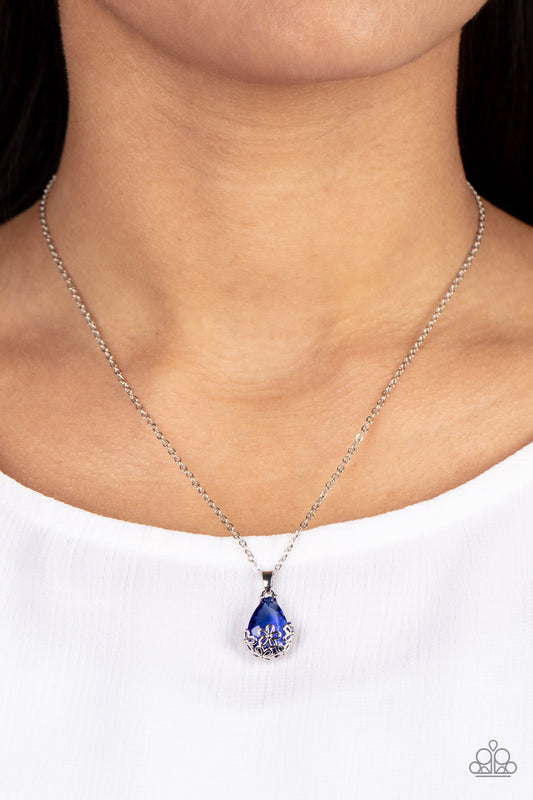 Flower Patch Fabulous Blue Necklace - Paparazzi Accessories  Dainty silver flowers adorn the bottom of a sparkly blue teardrop gem at the bottom of a dainty silver chain, creating a prismatic pendant below the collar. Features an adjustable clasp closure.  Sold as one individual necklace. Includes one pair of matching earrings.