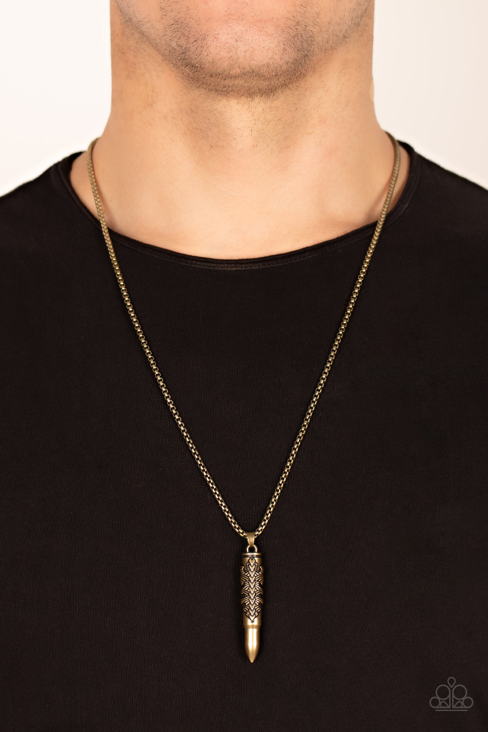 Mysterious Marksman Brass Urban Necklace - Paparazzi Accessories  Wrapped in a tribal inspired motif, a rustic bullet-like pendant swings from the bottom of a rounded strand of brass box chain for a rustic look. Features an adjustable clasp closure.  Sold as one individual necklace.